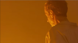 The Doctor looking down into the Thames, everything orange... 